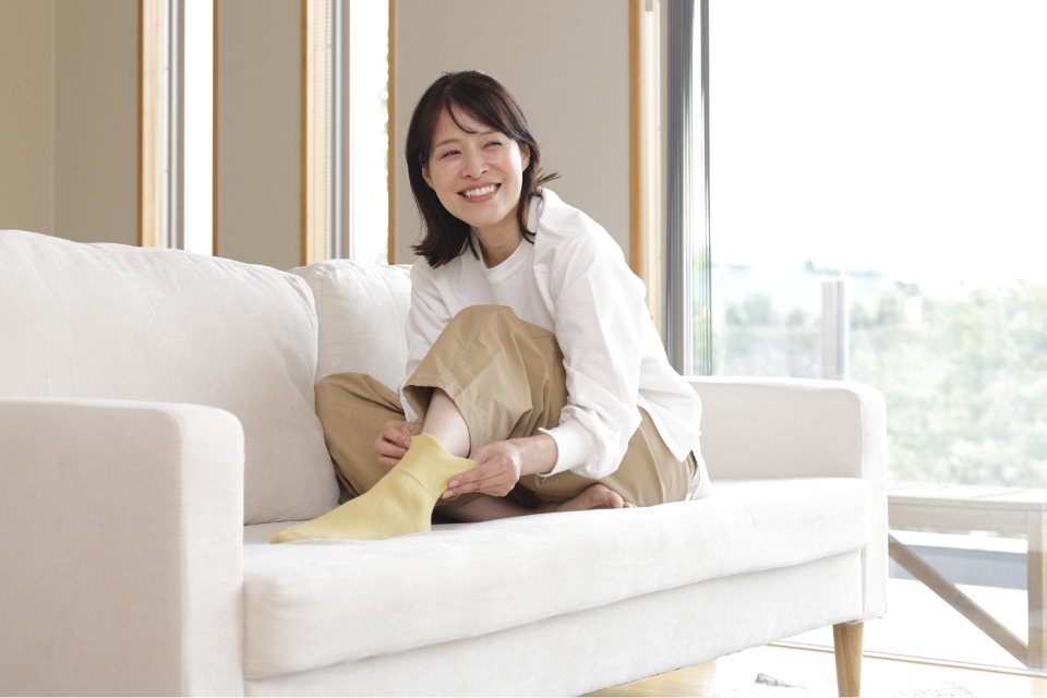 靴下生地を手に取りながら会話する男性と女性